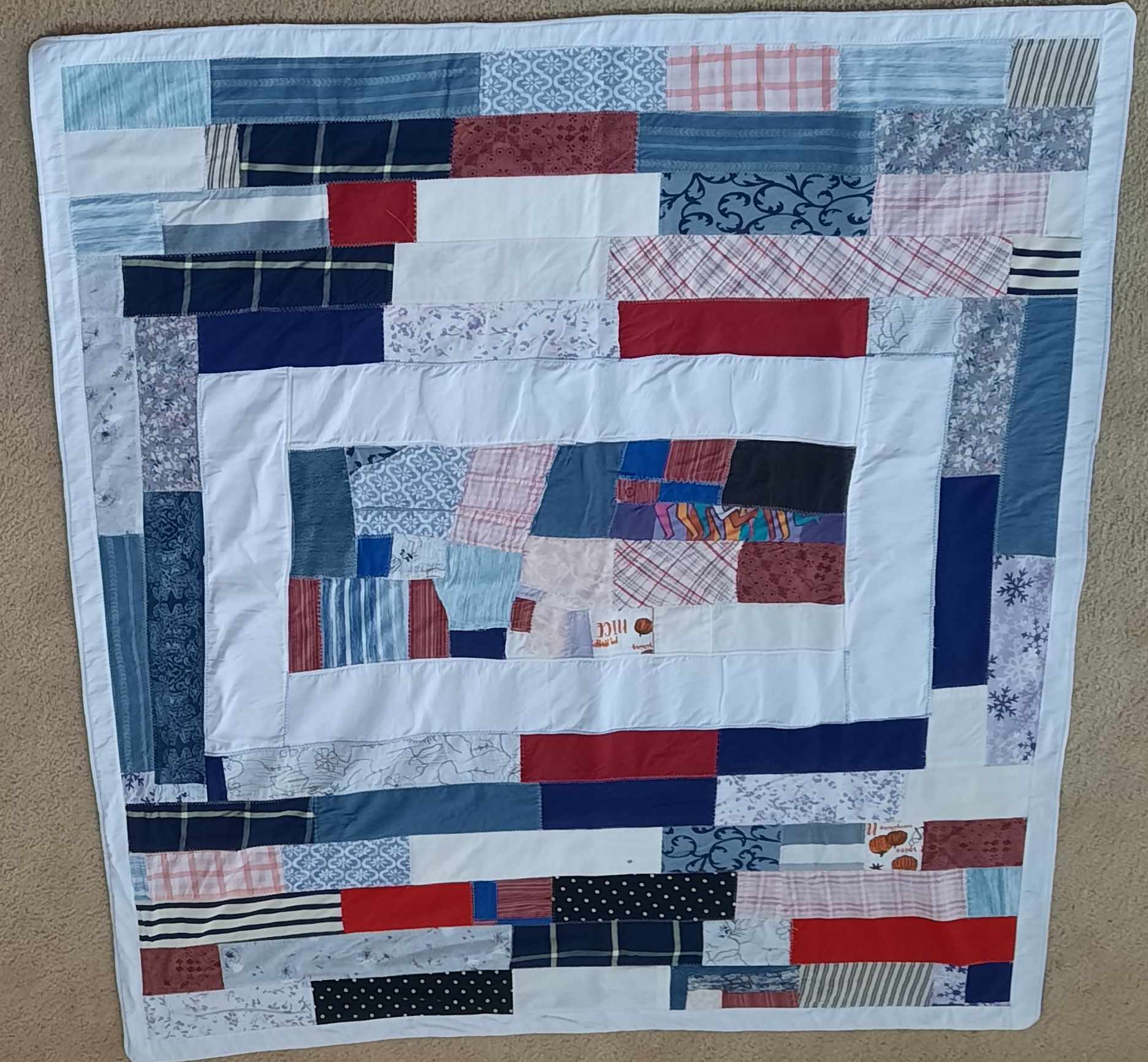 Quilt with unique center square, offcuts put together.
